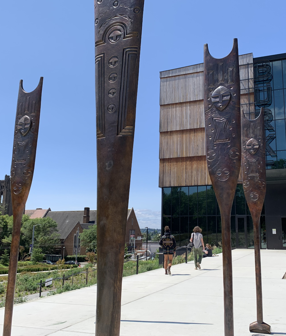 Outdoor artwork of carved, upright, bronze paddles at the Burke Museum in Seattle.
