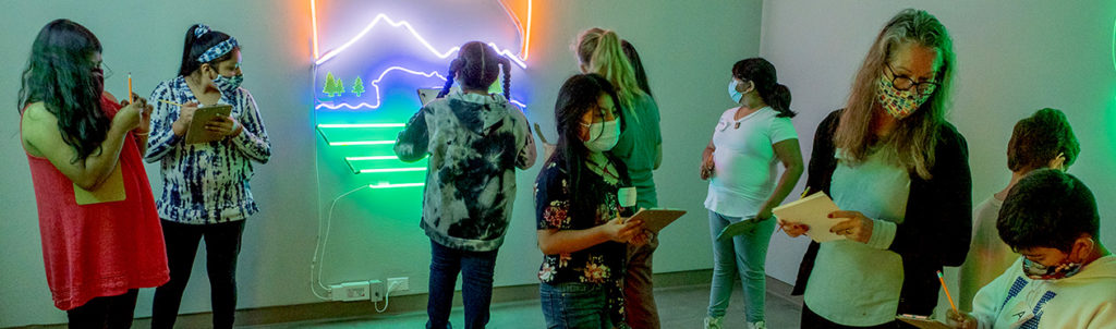 Students spend time drawing in the glass galleries at Museum of Northwest Art (MoNA).