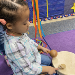 child playing hand drum